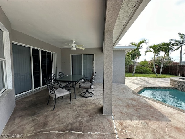 view of patio / terrace with a fenced in pool and ceiling fan