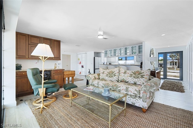 living room featuring ceiling fan and light hardwood / wood-style floors