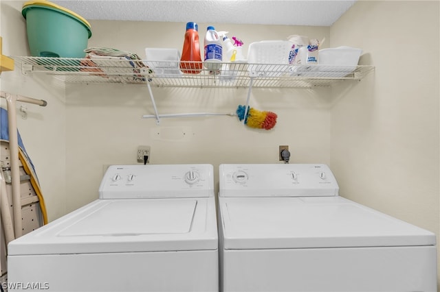 laundry room featuring a textured ceiling and washer and dryer