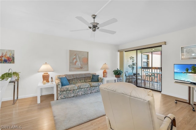 living room featuring light hardwood / wood-style floors and ceiling fan