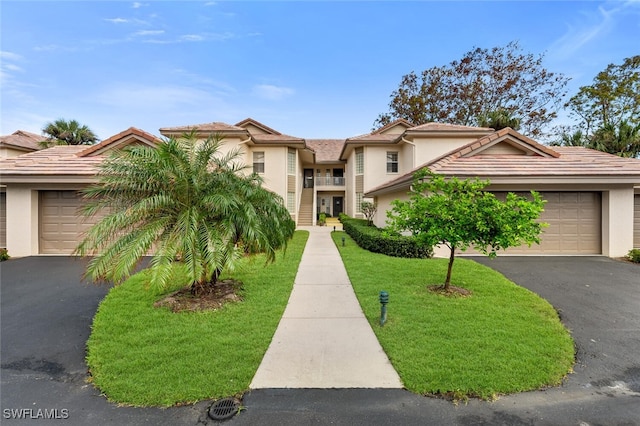 view of front of house with a garage and a front yard