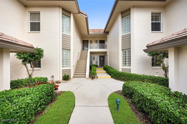 property entrance with stucco siding