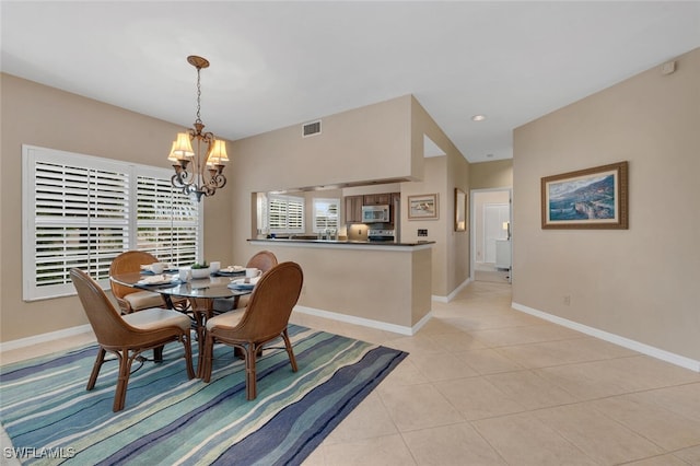 dining area featuring baseboards, light tile patterned floors, a notable chandelier, and visible vents