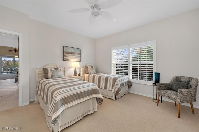 carpeted bedroom featuring access to exterior, ceiling fan, and baseboards