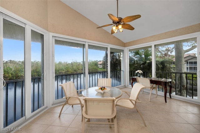 sunroom / solarium featuring a water view, vaulted ceiling, and ceiling fan