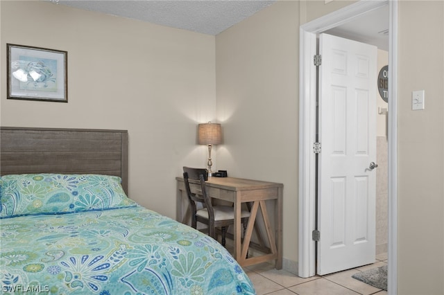 bedroom featuring light tile patterned flooring and a textured ceiling