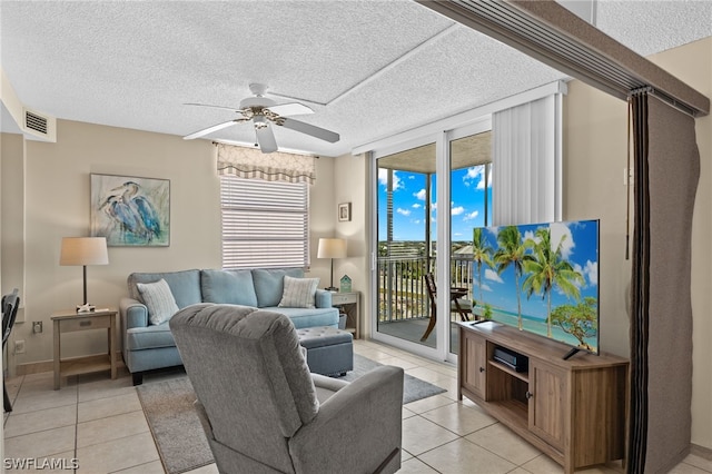 tiled living room featuring a textured ceiling and ceiling fan