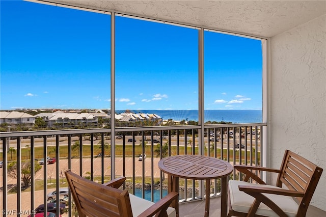 balcony featuring a water view