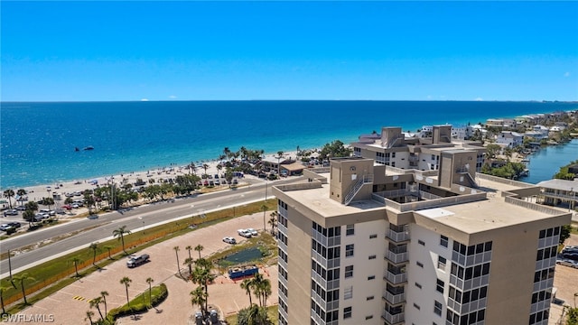 birds eye view of property featuring a water view and a beach view