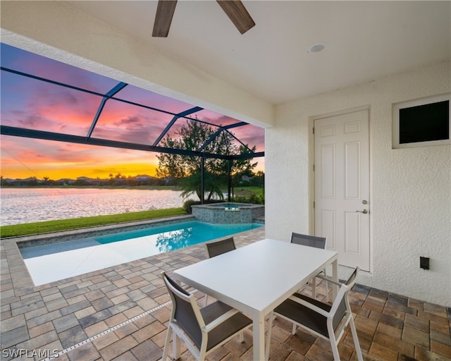 view of swimming pool featuring outdoor dining space, a patio area, glass enclosure, and a pool with connected hot tub