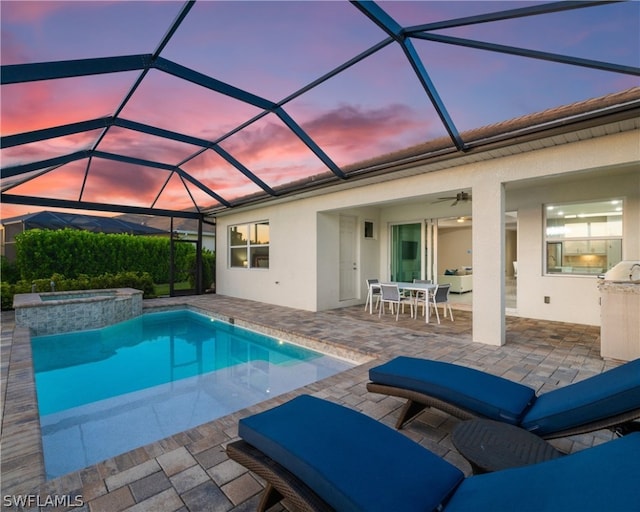 view of pool featuring a lanai, a patio, outdoor dining area, and ceiling fan