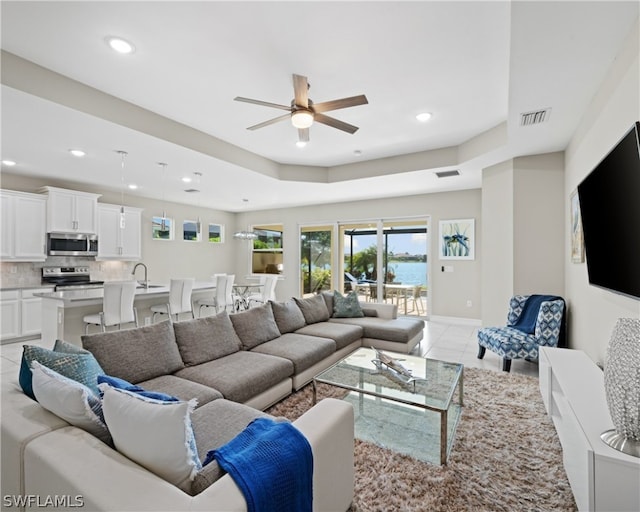 living room featuring light tile patterned floors, ceiling fan, visible vents, and recessed lighting