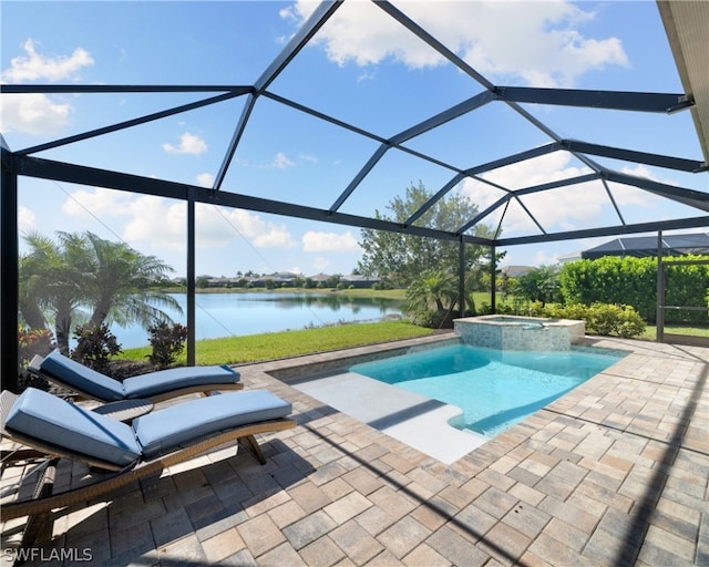 view of pool featuring a pool with connected hot tub, glass enclosure, a water view, and a patio