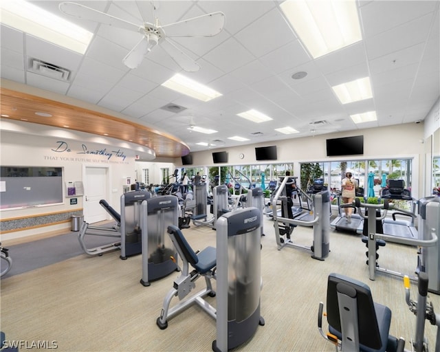 gym with a paneled ceiling, visible vents, and light carpet