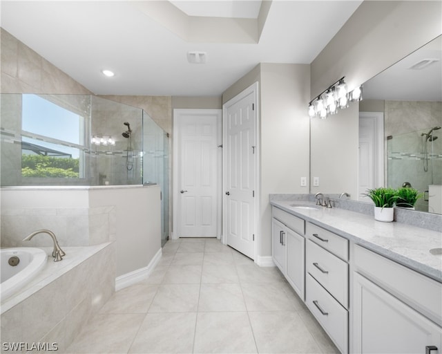 bathroom featuring double vanity, a stall shower, tile patterned flooring, and a sink