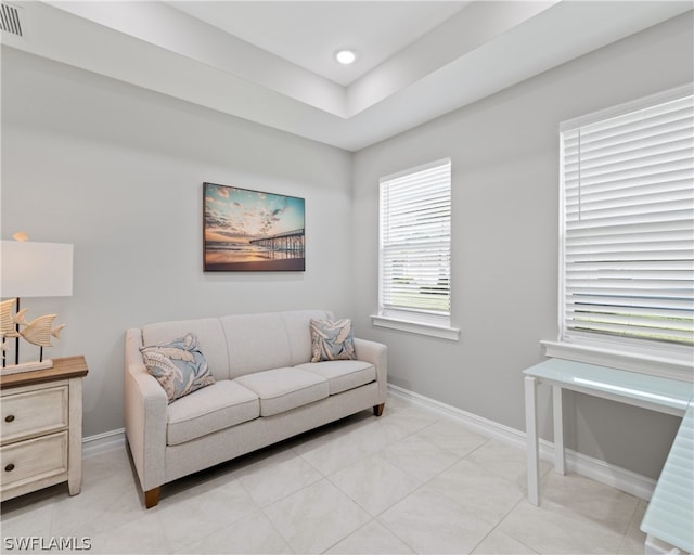 living area featuring light tile patterned floors, recessed lighting, visible vents, and baseboards