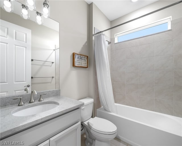 full bath featuring toilet, shower / bath combo with shower curtain, and vanity