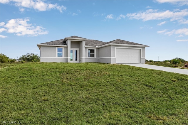 prairie-style house featuring a garage and a front lawn