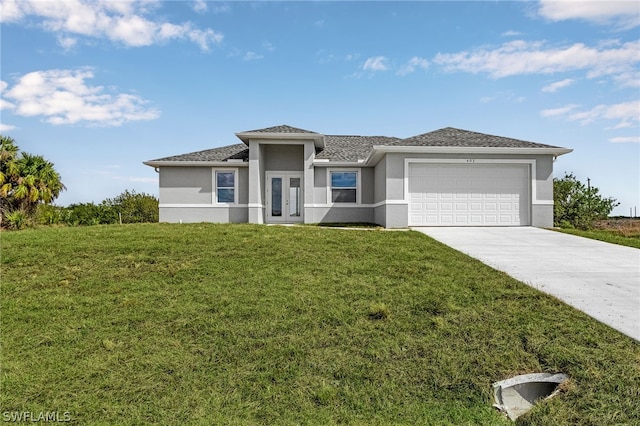 prairie-style home with french doors, a front lawn, and a garage