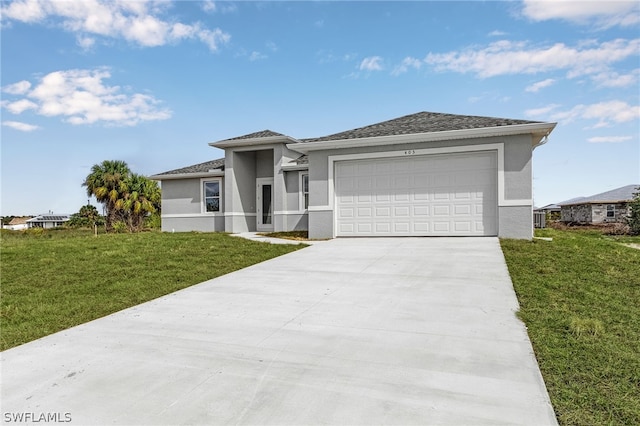 view of front of home with a front yard and a garage