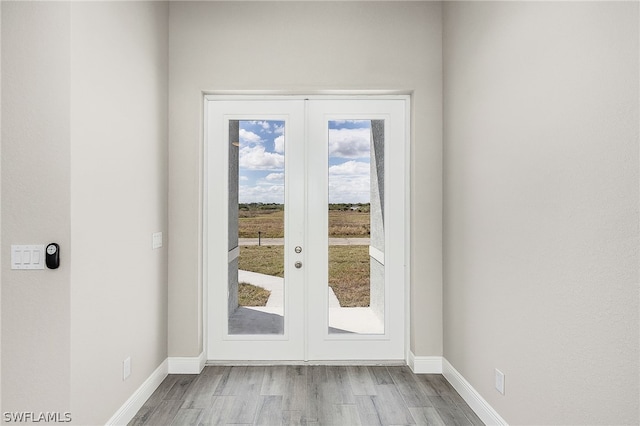 doorway featuring french doors and light wood-type flooring