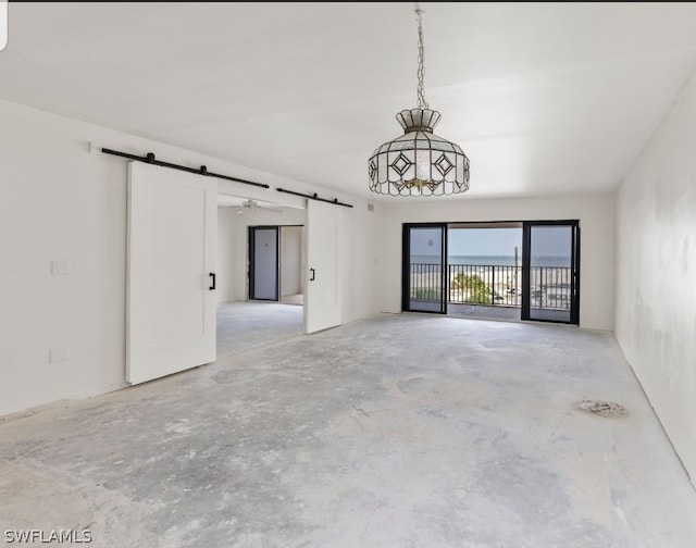 unfurnished room with a barn door