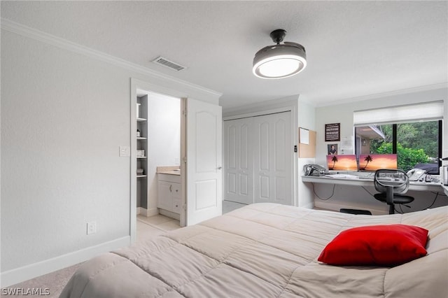 carpeted bedroom with crown molding and a closet