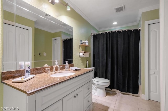 bathroom with tile patterned floors, crown molding, vanity, and toilet