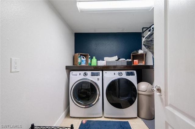 clothes washing area featuring separate washer and dryer and light tile patterned floors