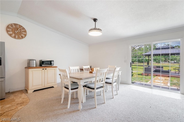 dining area featuring plenty of natural light, lofted ceiling, and ornamental molding