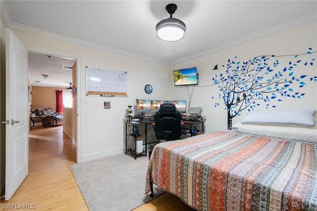 bedroom featuring light hardwood / wood-style floors and ornamental molding