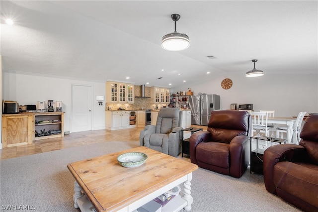 carpeted living room featuring vaulted ceiling