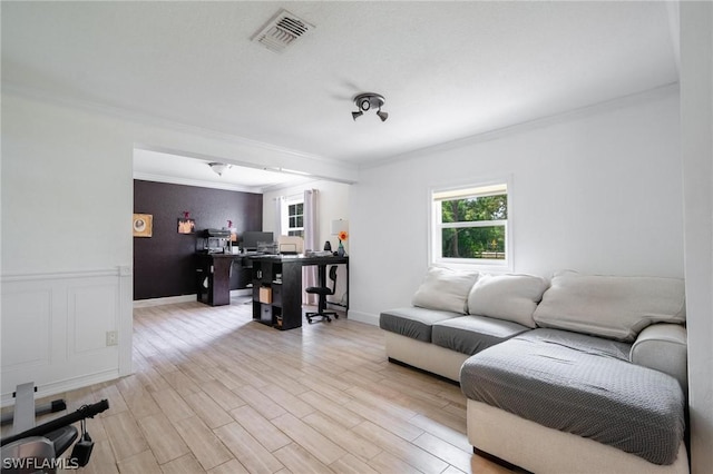 living room featuring ornamental molding and light hardwood / wood-style flooring