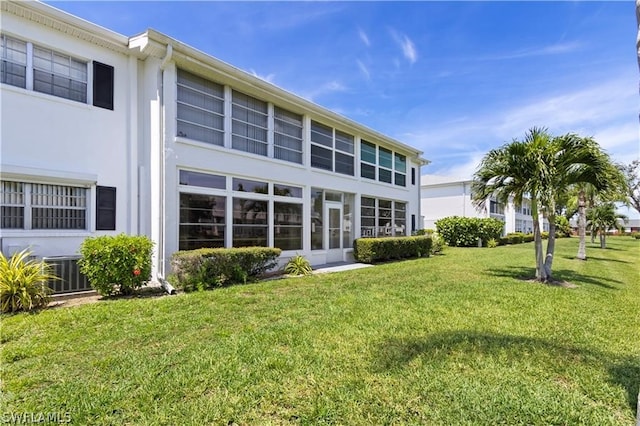 rear view of property featuring a yard