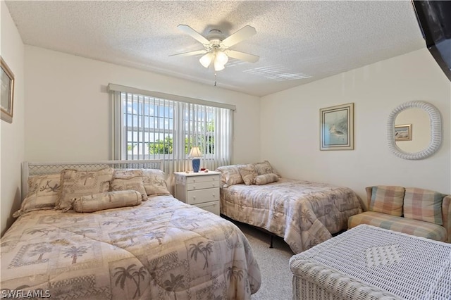 bedroom with a textured ceiling, ceiling fan, and carpet flooring