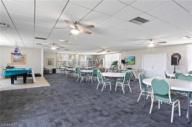 carpeted dining space featuring a drop ceiling, ceiling fan, and billiards