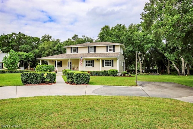 view of front facade with a front yard and a porch