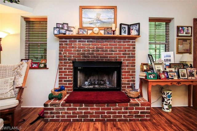 room details with a brick fireplace and wood-type flooring