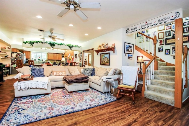 living room featuring ceiling fan and hardwood / wood-style floors