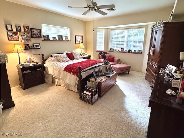 bedroom featuring light carpet and ceiling fan