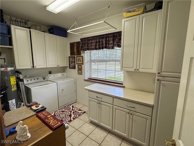 laundry room with independent washer and dryer, cabinets, water heater, and light tile patterned floors