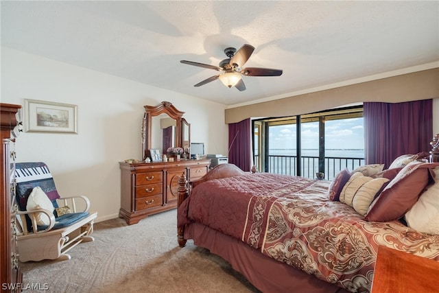 carpeted bedroom featuring ceiling fan and access to exterior