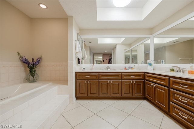 bathroom with double vanity, tiled tub, and tile floors