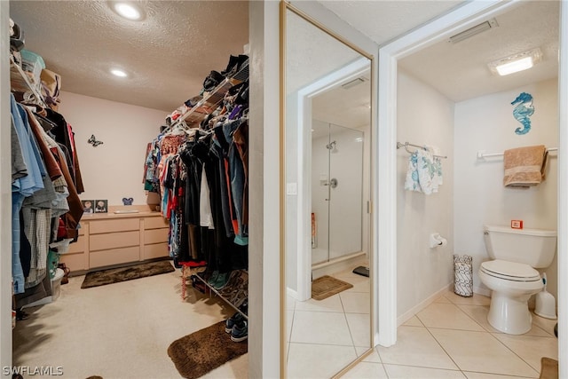 walk in closet featuring light tile flooring