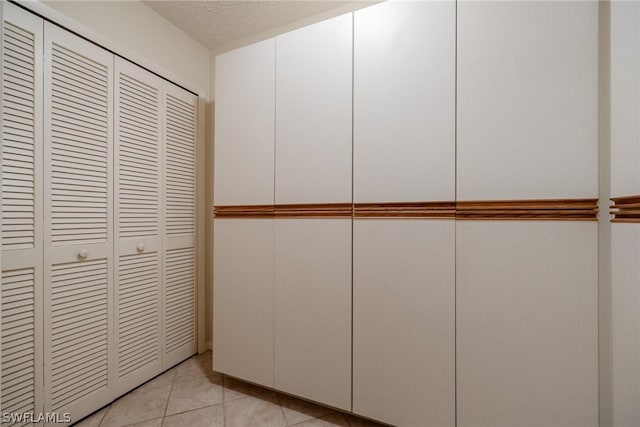 room details with a textured ceiling and light tile flooring