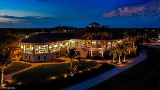 view of back house at dusk