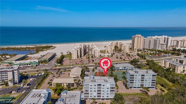 drone / aerial view featuring a water view and a view of the beach