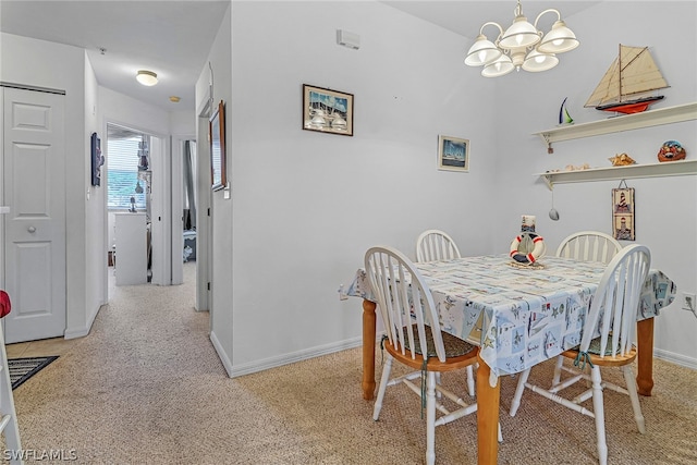 carpeted dining space with a chandelier