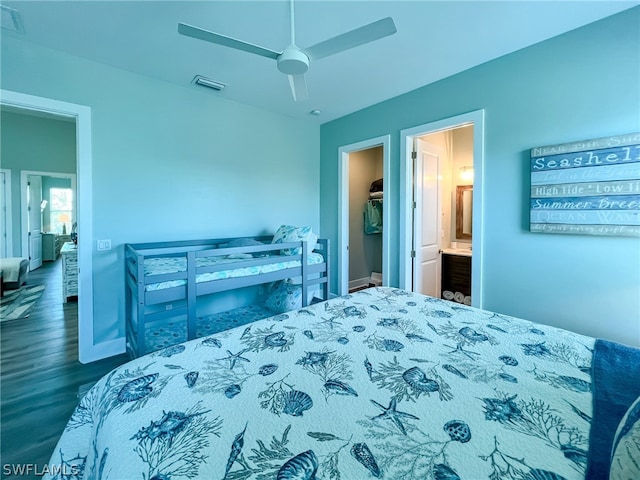 bedroom featuring ceiling fan, ensuite bathroom, and dark wood-type flooring