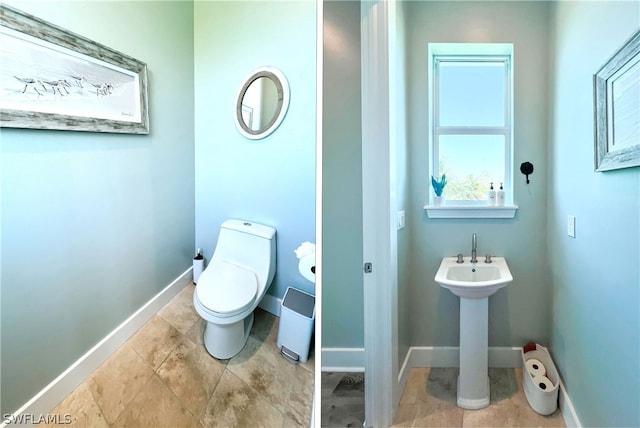 bathroom featuring tile floors and toilet